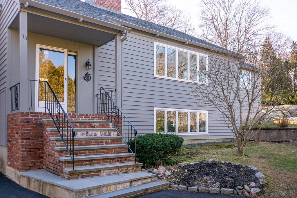 33 Windy Hill Road Cohasset, MA 02025 - Photo 8 of 42 a front view of a house with garden