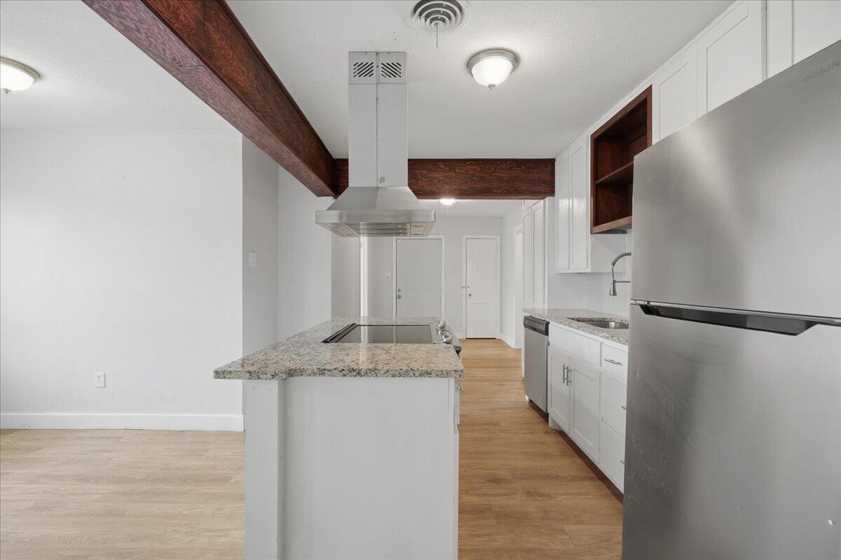 2503 30th Street Lubbock, TX 79410 - Photo 7 of 26 a kitchen with stainless steel appliances granite countertop a refrigerator a oven a sink with island and chairs