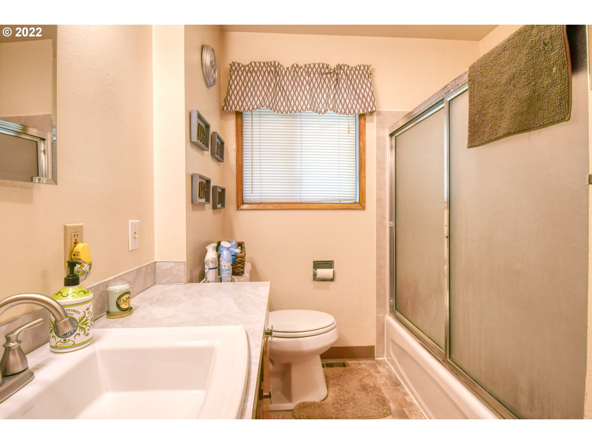 3308 Southwest Kirk Avenue Pendleton, OR 97801 - Photo 16 of 32 a bathroom with a sink a toilet and a mirror