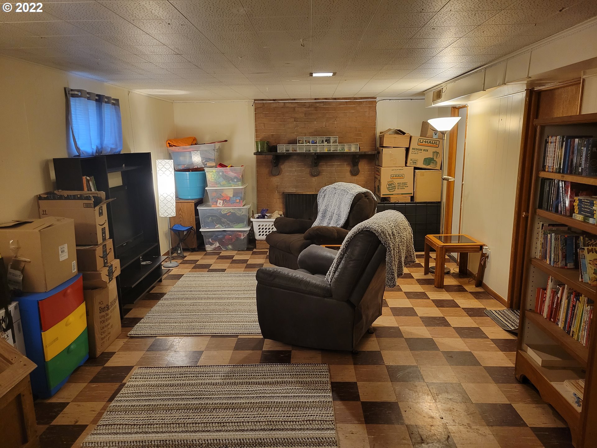 3308 Southwest Kirk Avenue Pendleton, OR 97801 - Photo 23 of 32 a living room with furniture a fireplace and a book shelf