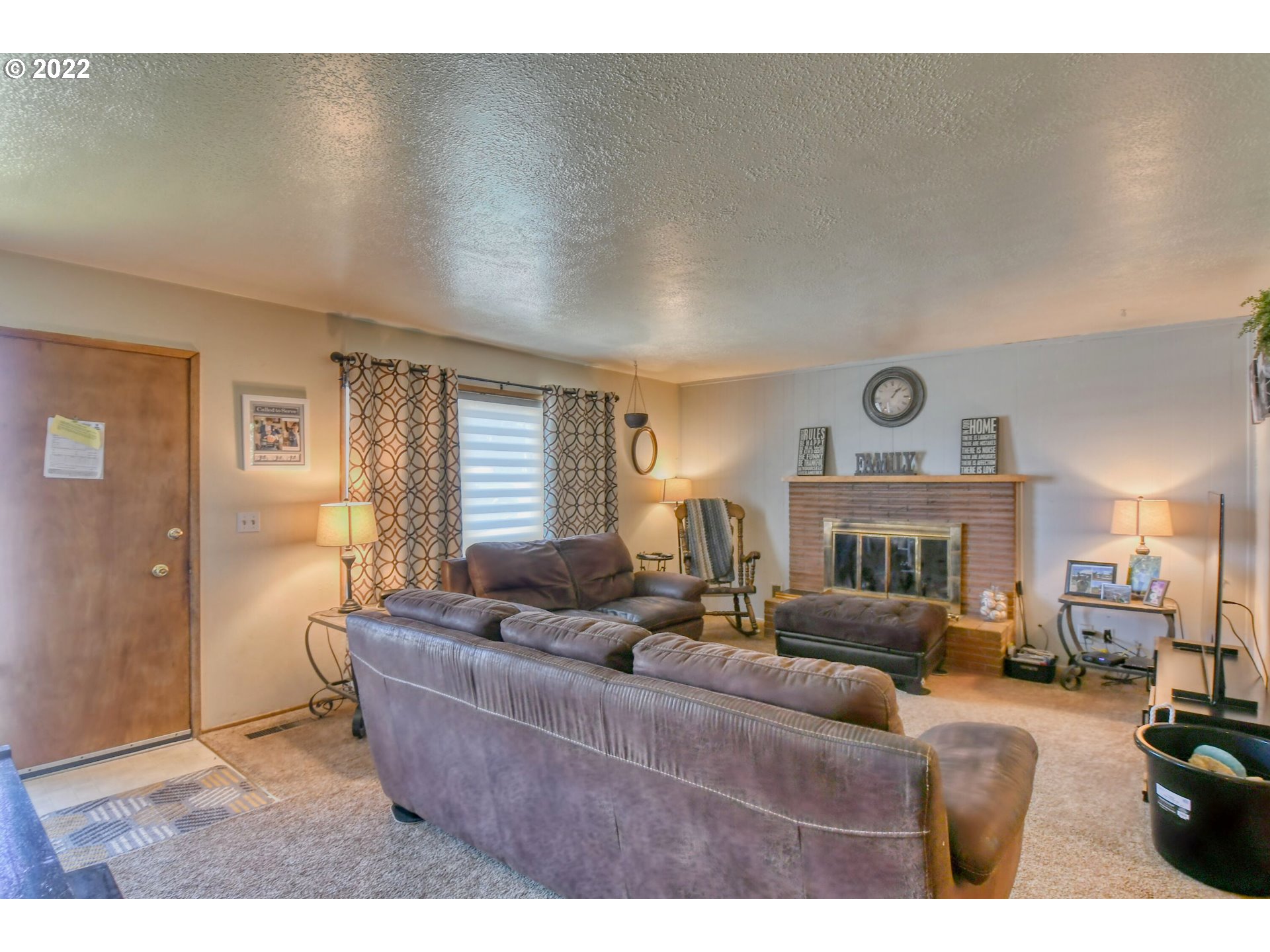 3308 Southwest Kirk Avenue Pendleton, OR 97801 - Photo 3 of 32 a living room with furniture and a fireplace