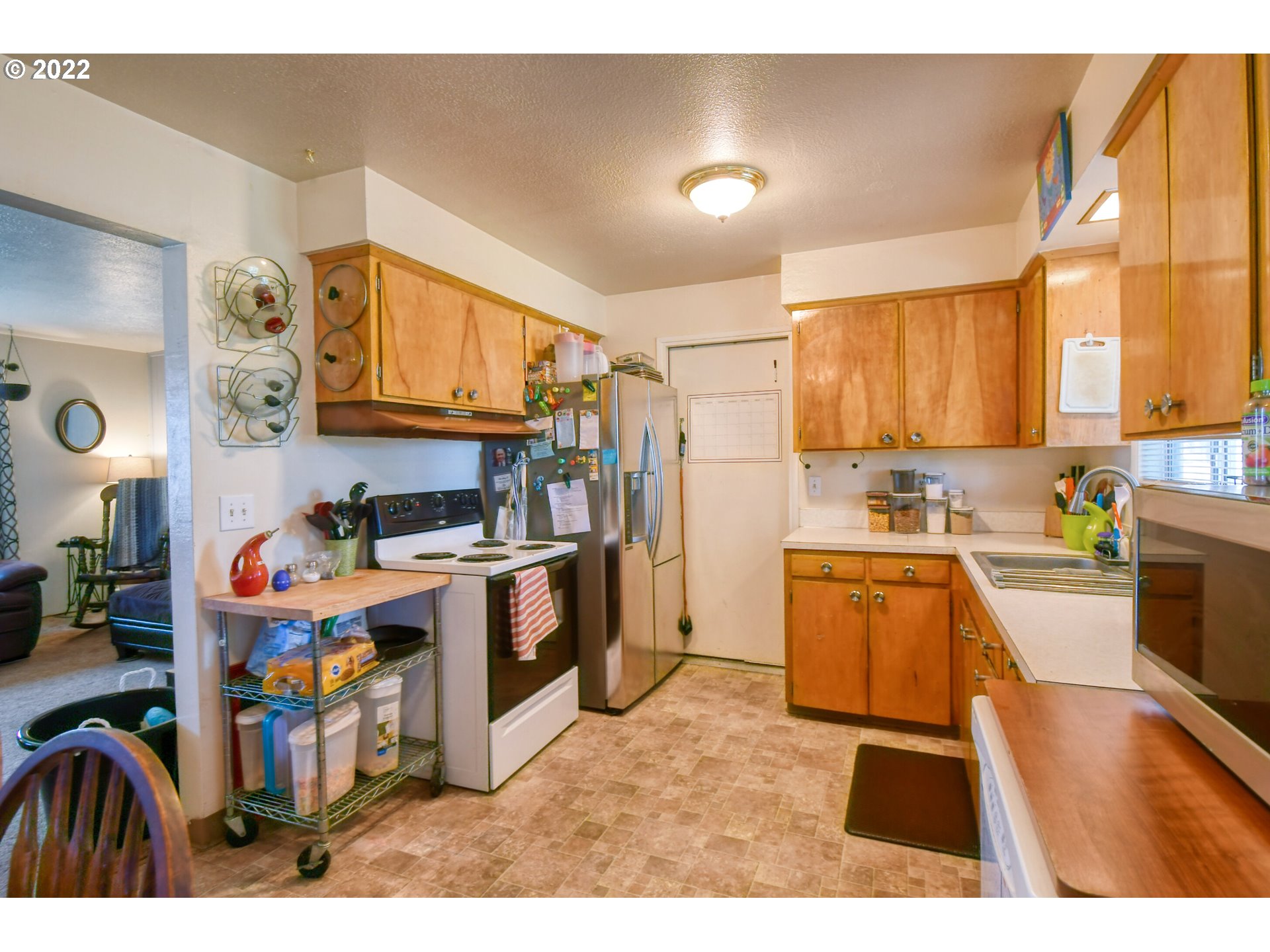 3308 Southwest Kirk Avenue Pendleton, OR 97801 - Photo 7 of 32 a kitchen that has a lot of cabinets a sink and a stove in it