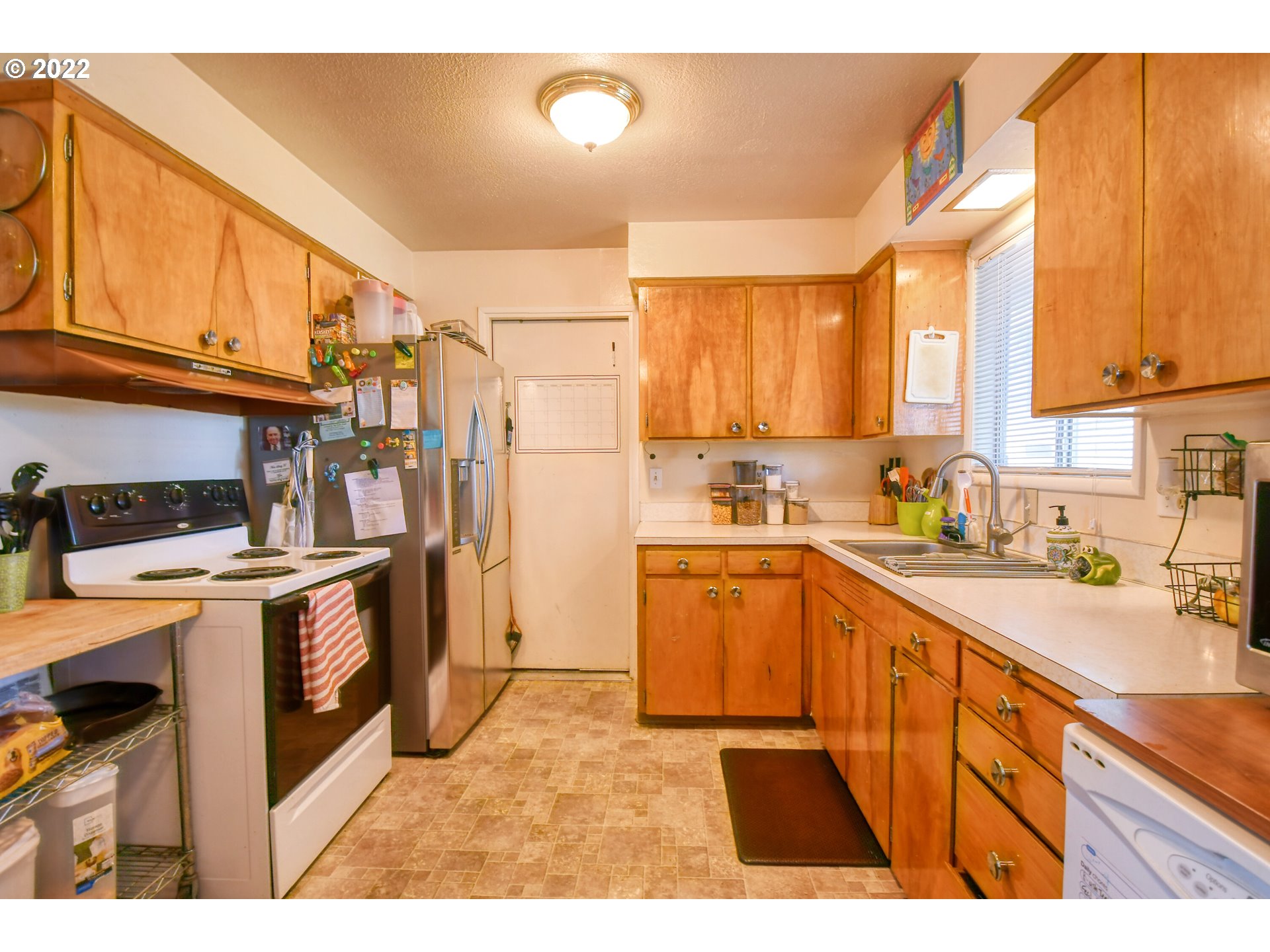 3308 Southwest Kirk Avenue Pendleton, OR 97801 - Photo 10 of 32 a kitchen with stainless steel appliances kitchen island wooden cabinets a sink and a stove