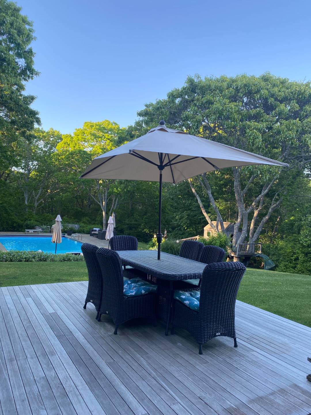 6 Wills Point Road Montauk, NY 11954 - Photo 15 of 16 a view of a table and chairs under an umbrella in a yard