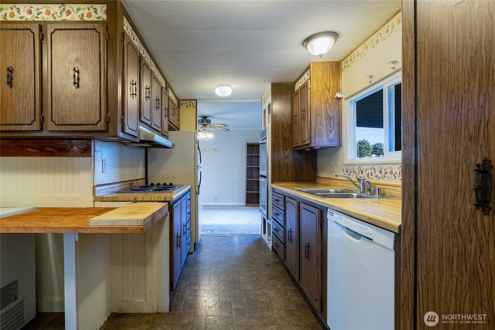 826 Southeast Scenic View Drive College Place, WA 99324 - Photo 16 of 28 a kitchen with stainless steel appliances granite countertop a stove a sink and a refrigerator
