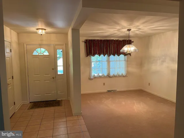 en empty room with windows and entrance