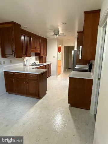 a kitchen with granite countertop a sink and cabinets