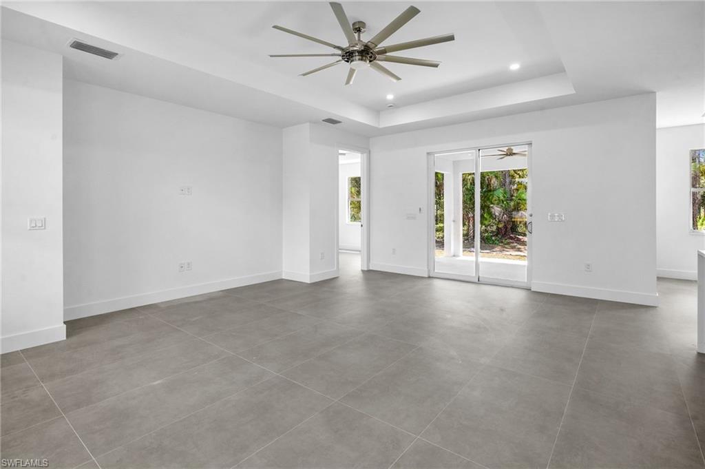 2712 40th Avenue Southeast Naples, FL 34117 - Photo 13 of 41 wooden floor in an empty room with a window