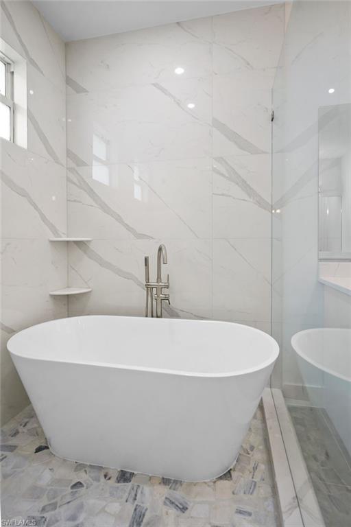 2712 40th Avenue Southeast Naples, FL 34117 - Photo 19 of 41 a white bath tub sitting in a bathroom