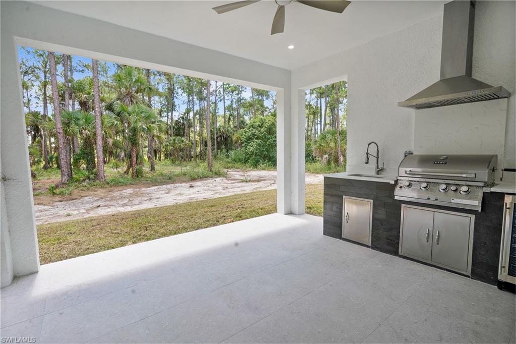2712 40th Avenue Southeast Naples, FL 34117 - Photo 26 of 41 a kitchen with a stove and a view of living room