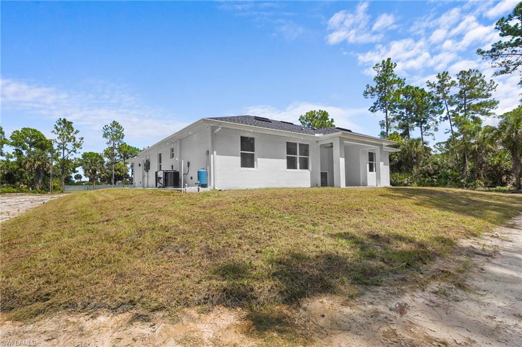 2712 40th Avenue Southeast Naples, FL 34117 - Photo 28 of 41 a front view of a house with a yard