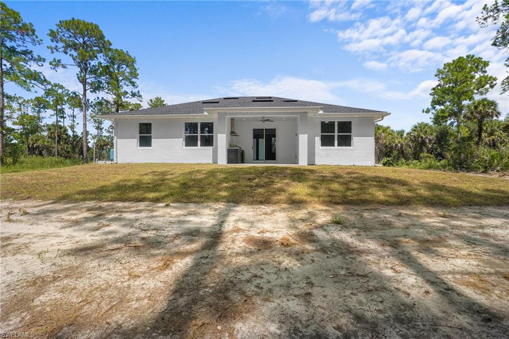 2712 40th Avenue Southeast Naples, FL 34117 - Photo 29 of 41 a front view of a house with a yard
