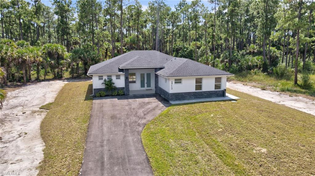 2712 40th Avenue Southeast Naples, FL 34117 - Photo 3 of 41 a view of a house with a backyard