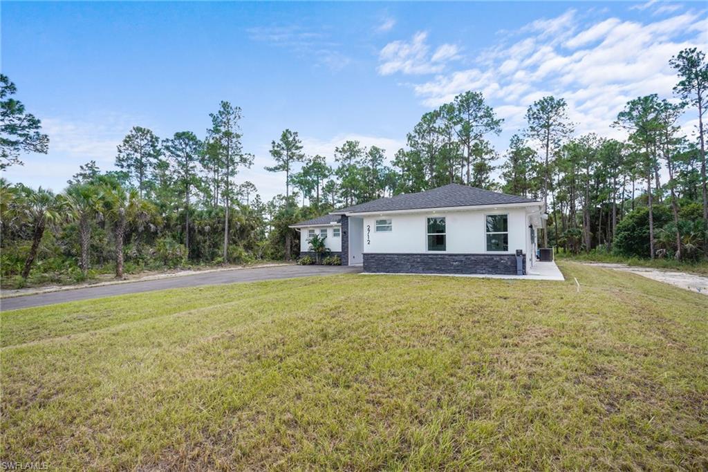 2712 40th Avenue Southeast Naples, FL 34117 - Photo 31 of 41 a house view with a garden space