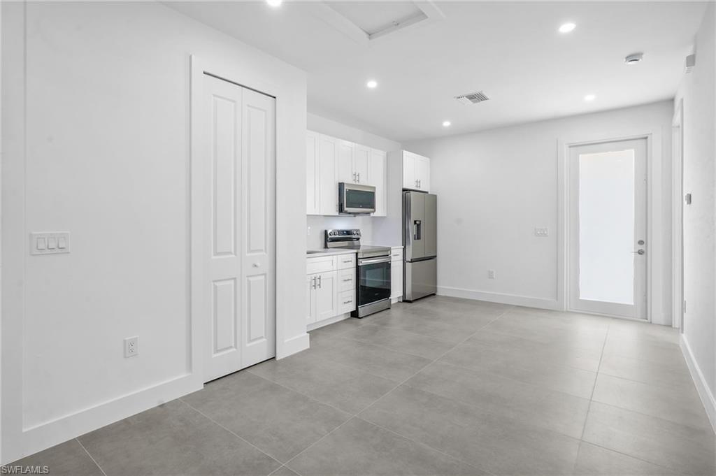 2712 40th Avenue Southeast Naples, FL 34117 - Photo 40 of 41 a view of a kitchen with refrigerator stove and cabinets