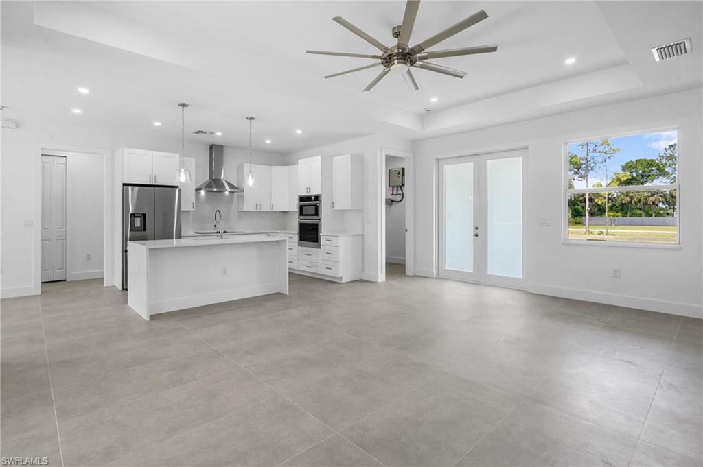 2712 40th Avenue Southeast Naples, FL 34117 - Photo 6 of 41 a view of a kitchen with a sink and a refrigerator