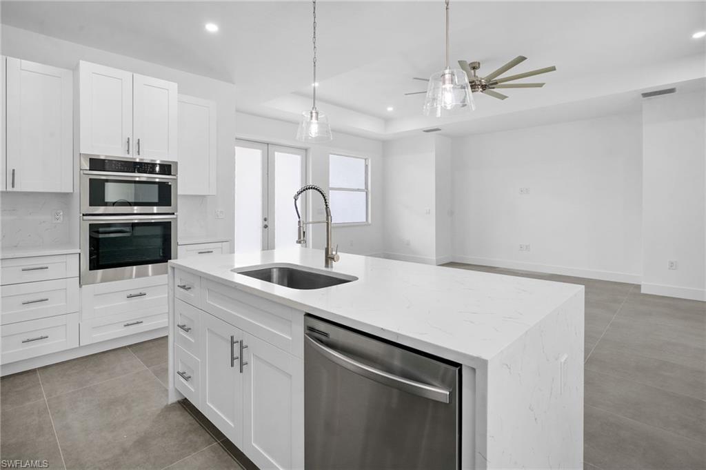 2712 40th Avenue Southeast Naples, FL 34117 - Photo 10 of 41 a kitchen with appliances a sink and cabinets