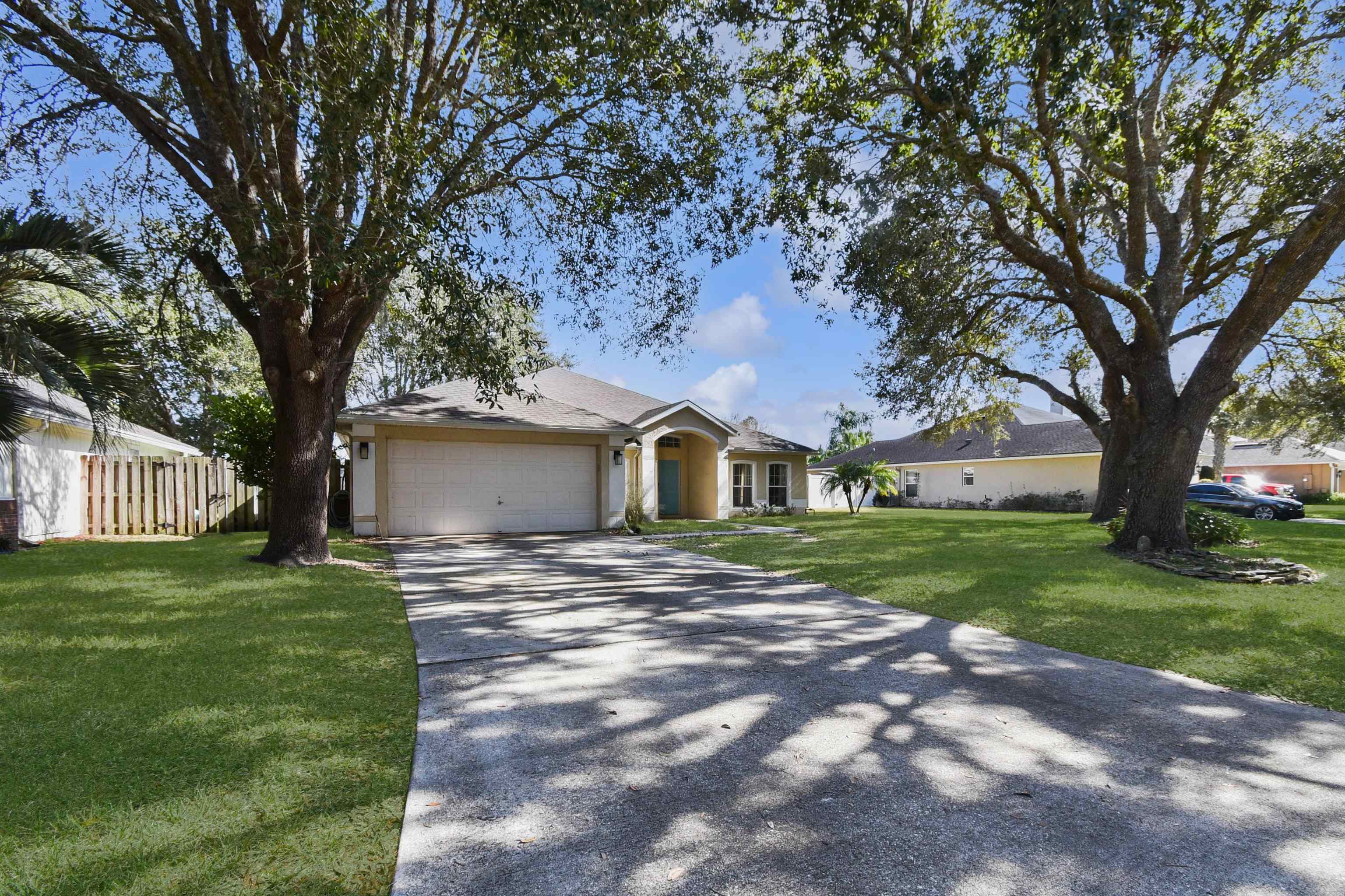 420 Bay Point Way North St. Johns, FL 32259 - Photo 5 of 37 a view of a yard in front of a house with a large tree