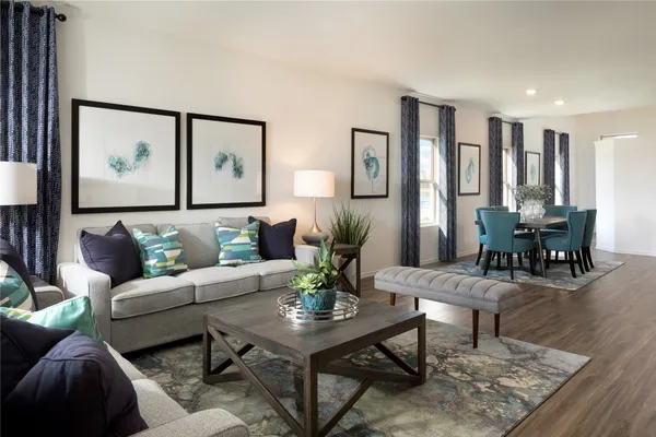 a living room with furniture and wooden floor