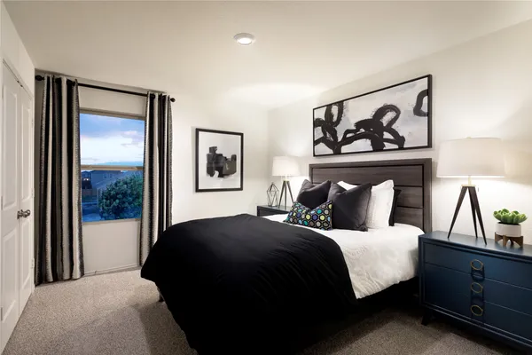 a bedroom with a bed and a painting on the wall