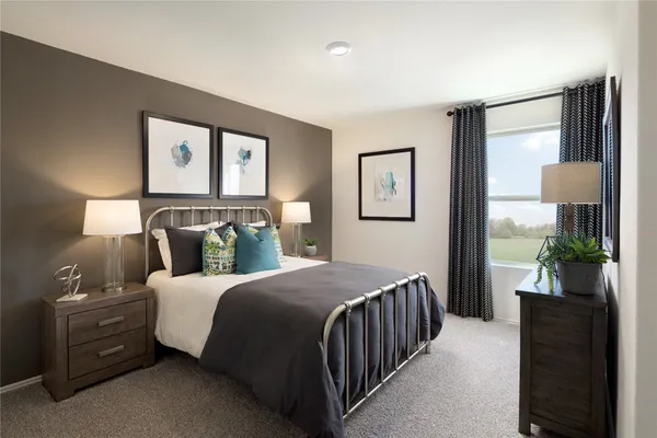 a bedroom with a bed and painting on the wall