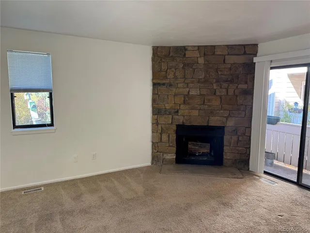 an empty room with a fireplace