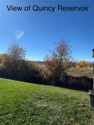 a view of a backyard with a wooden fence