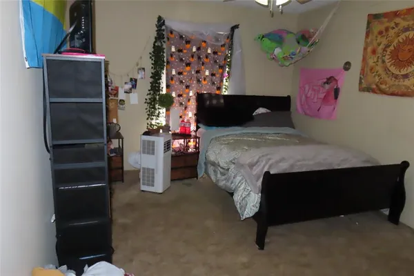 a bedroom with bed and a window