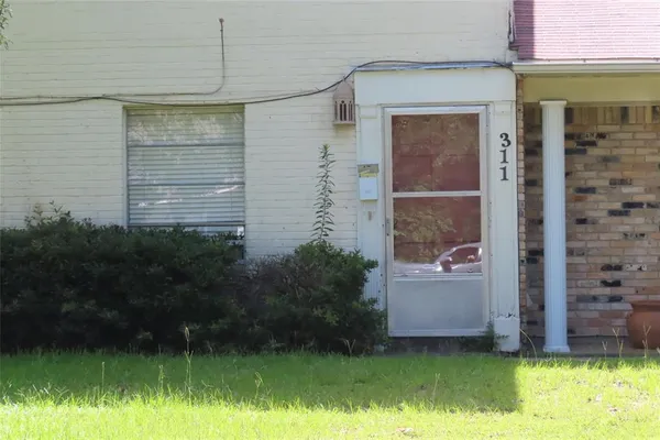 a view of a small house with a yard