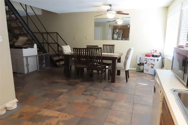 a dining room with furniture and a chandelier