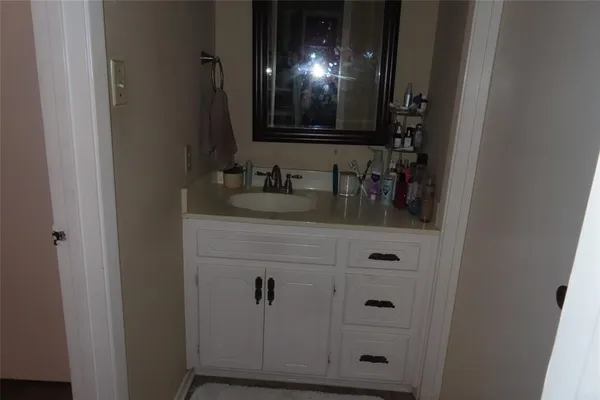 a bathroom with a sink and cabinets