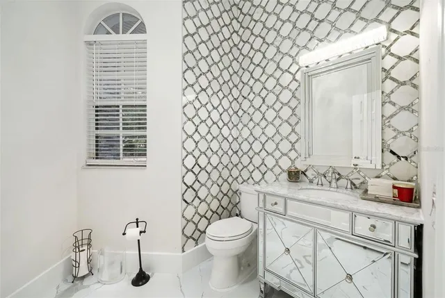 a bathroom with a sink toilet and mirror