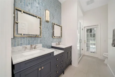 a bathroom with a sink double vanity and a mirror