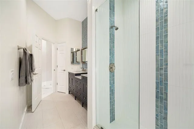 a kitchen with a refrigerator and a stove top oven