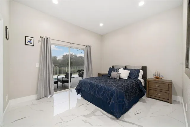 a bedroom with a bed and a large window