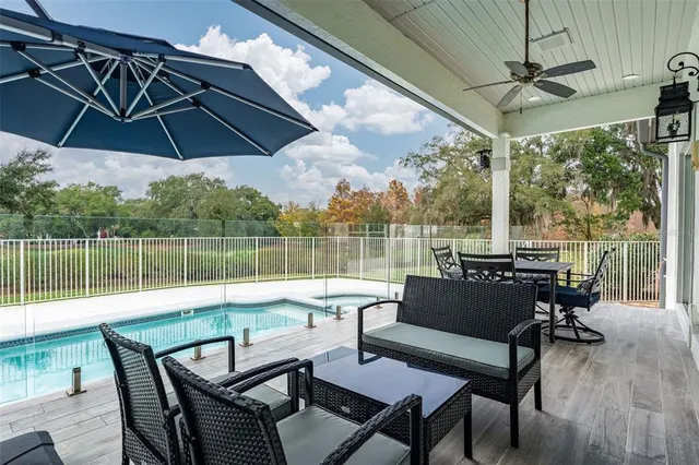 a view of a lake from a roof deck with furniture