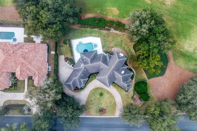 an aerial view of a house with outdoor space and lake view