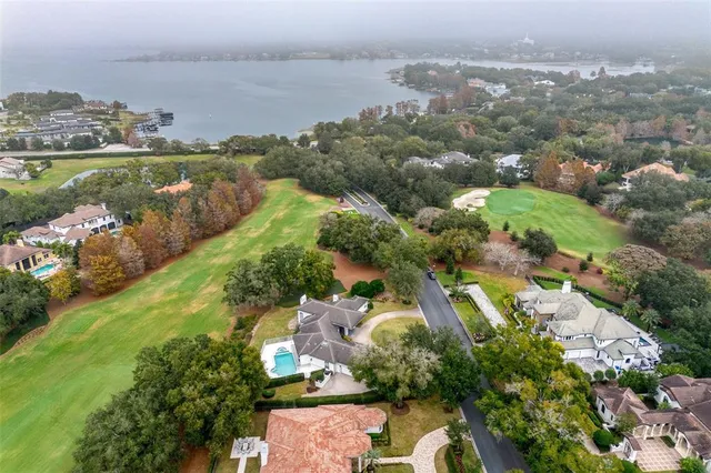 an aerial view of lake residential houses with outdoor space and swimming pool