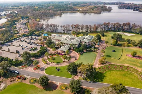 an aerial view of lake residential house with outdoor space and swimming pool