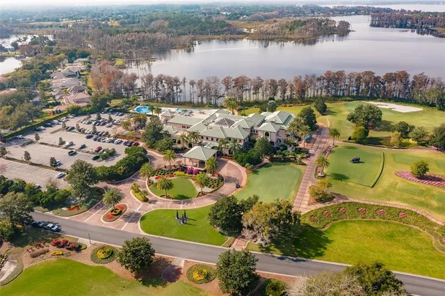 an aerial view of lake residential house with outdoor space and swimming pool