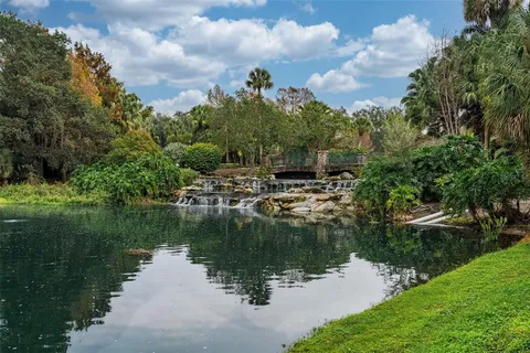 a backyard of a house with lots of green space and lake view
