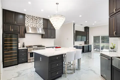 a kitchen with a stove a sink and a refrigerator