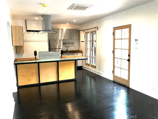 a kitchen with stainless steel appliances granite countertop a stove and a large window