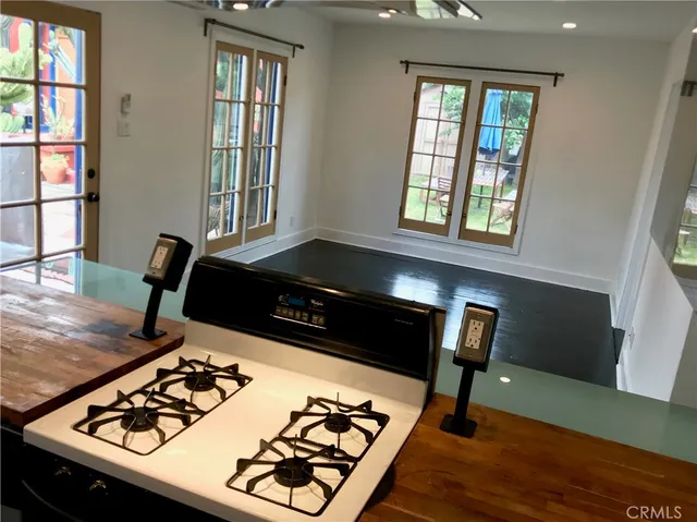 a kitchen with a stove and a window