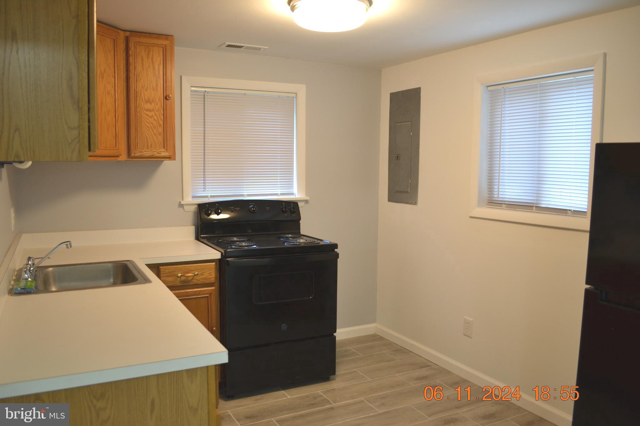 329 A Bar Harbor Road Pasadena, MD 21122 - Photo 13 of 18 a kitchen that has a sink and a stove in it