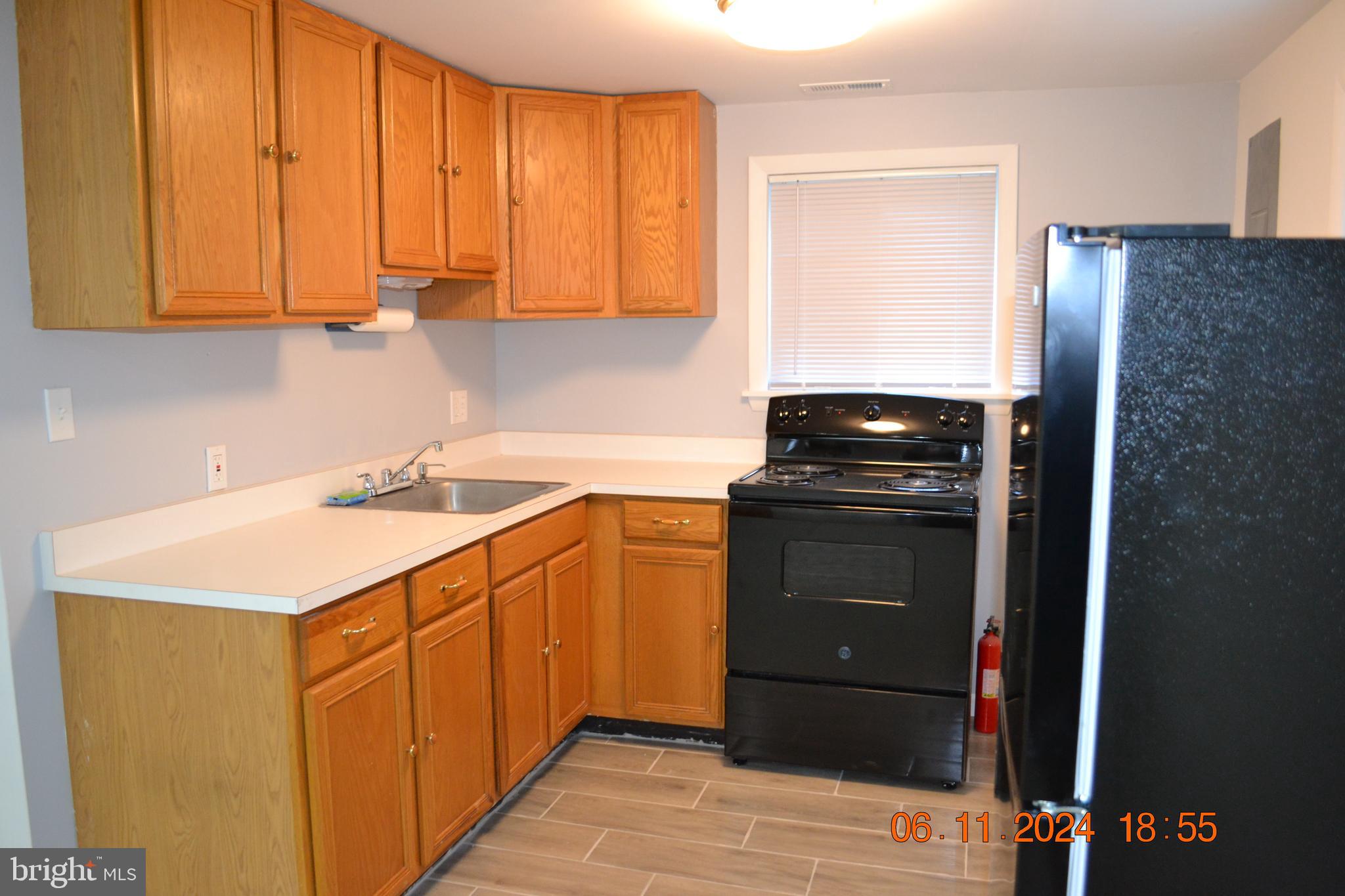329 A Bar Harbor Road Pasadena, MD 21122 - Photo 14 of 18 a kitchen with stainless steel appliances granite countertop a refrigerator and a stove top oven