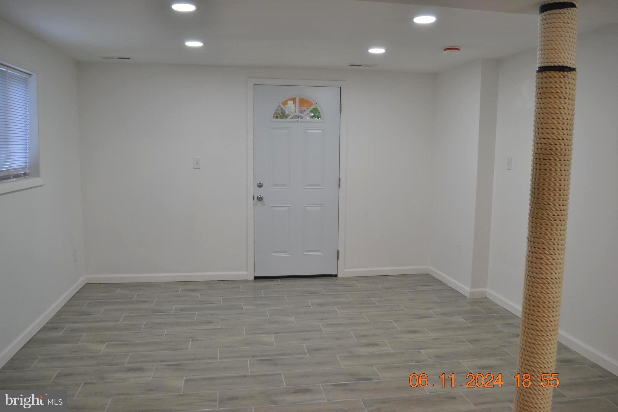 329 A Bar Harbor Road Pasadena, MD 21122 - Photo 15 of 18 a view of an empty room with wooden floor and a window