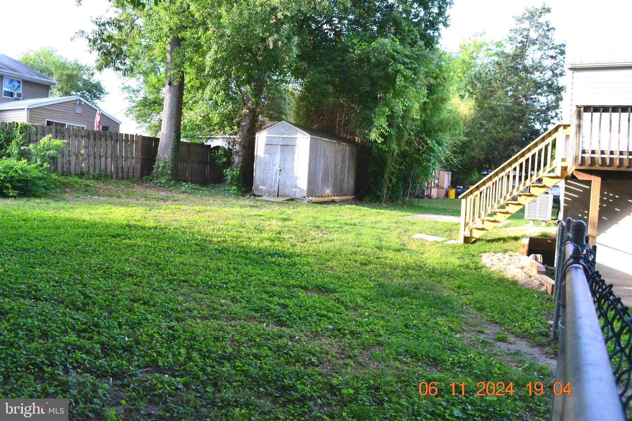 329 A Bar Harbor Road Pasadena, MD 21122 - Photo 16 of 18 a backyard of a house with lots of green space