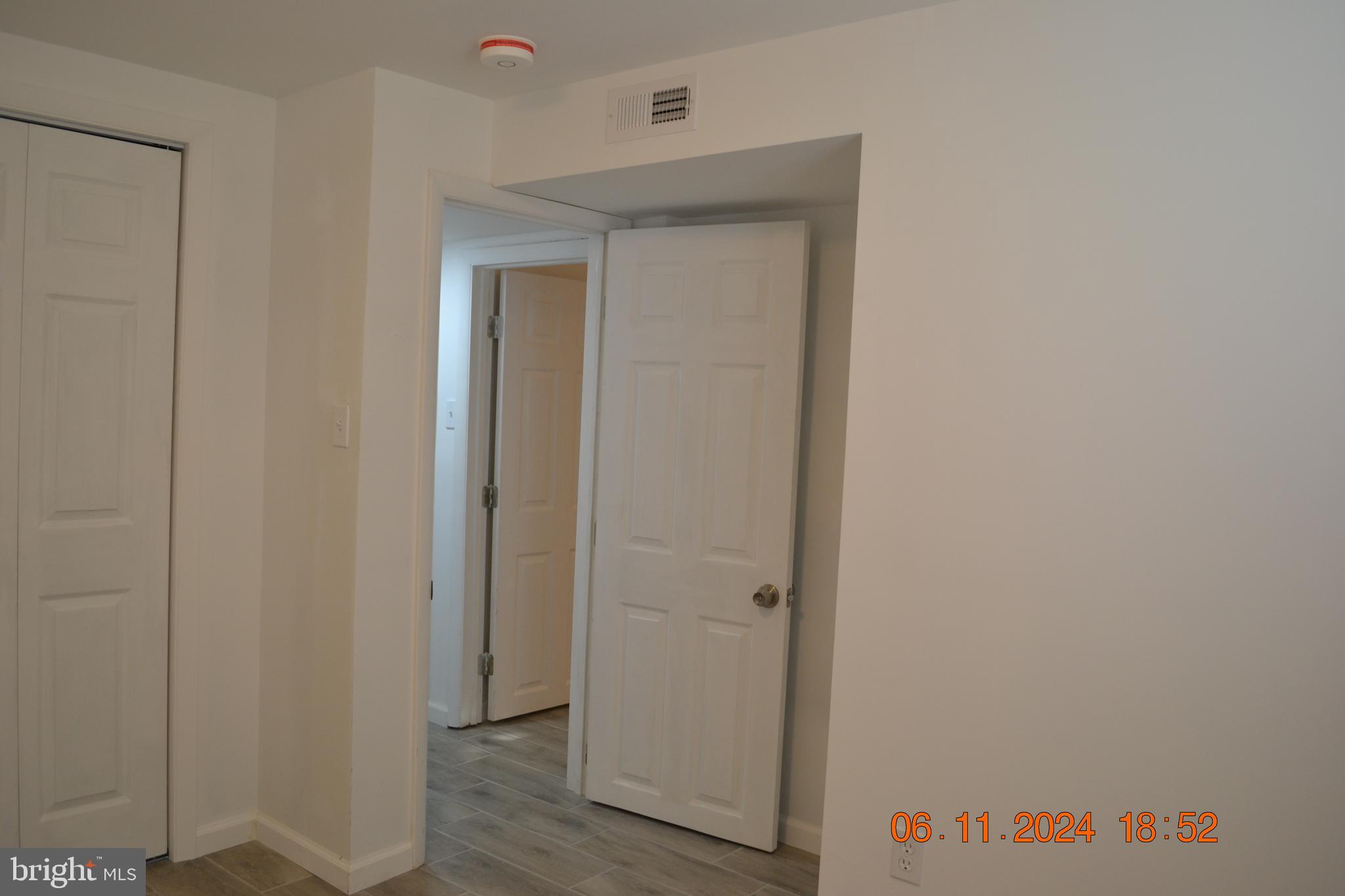 329 A Bar Harbor Road Pasadena, MD 21122 - Photo 9 of 18 a view of a hallway with wooden floor