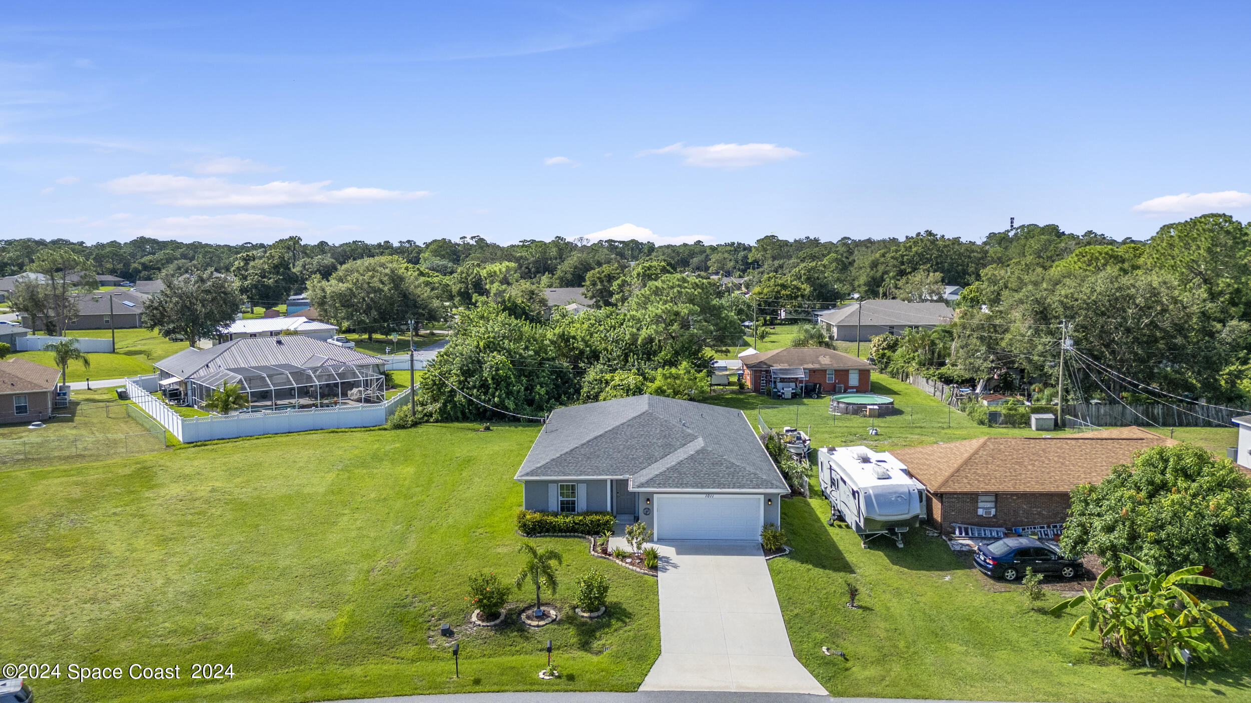 1011 Grapefruit Road Southeast Palm Bay, FL 32909 - Photo 2 of 42 a view of a house with pool and a yard